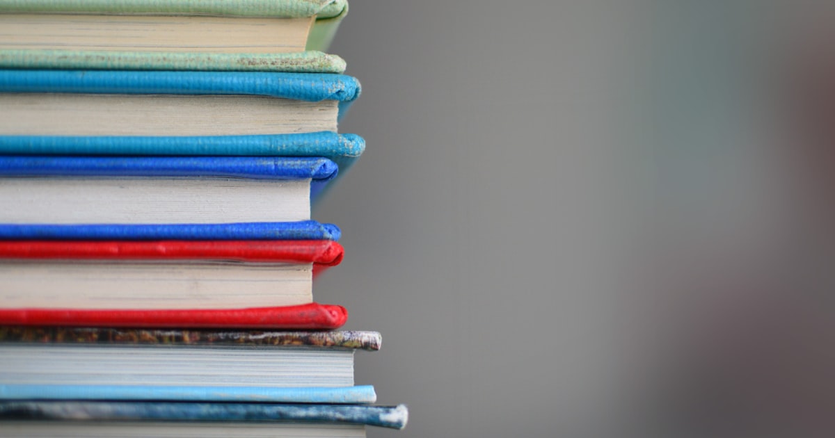 Student reviewing language textbooks and notes for an exam